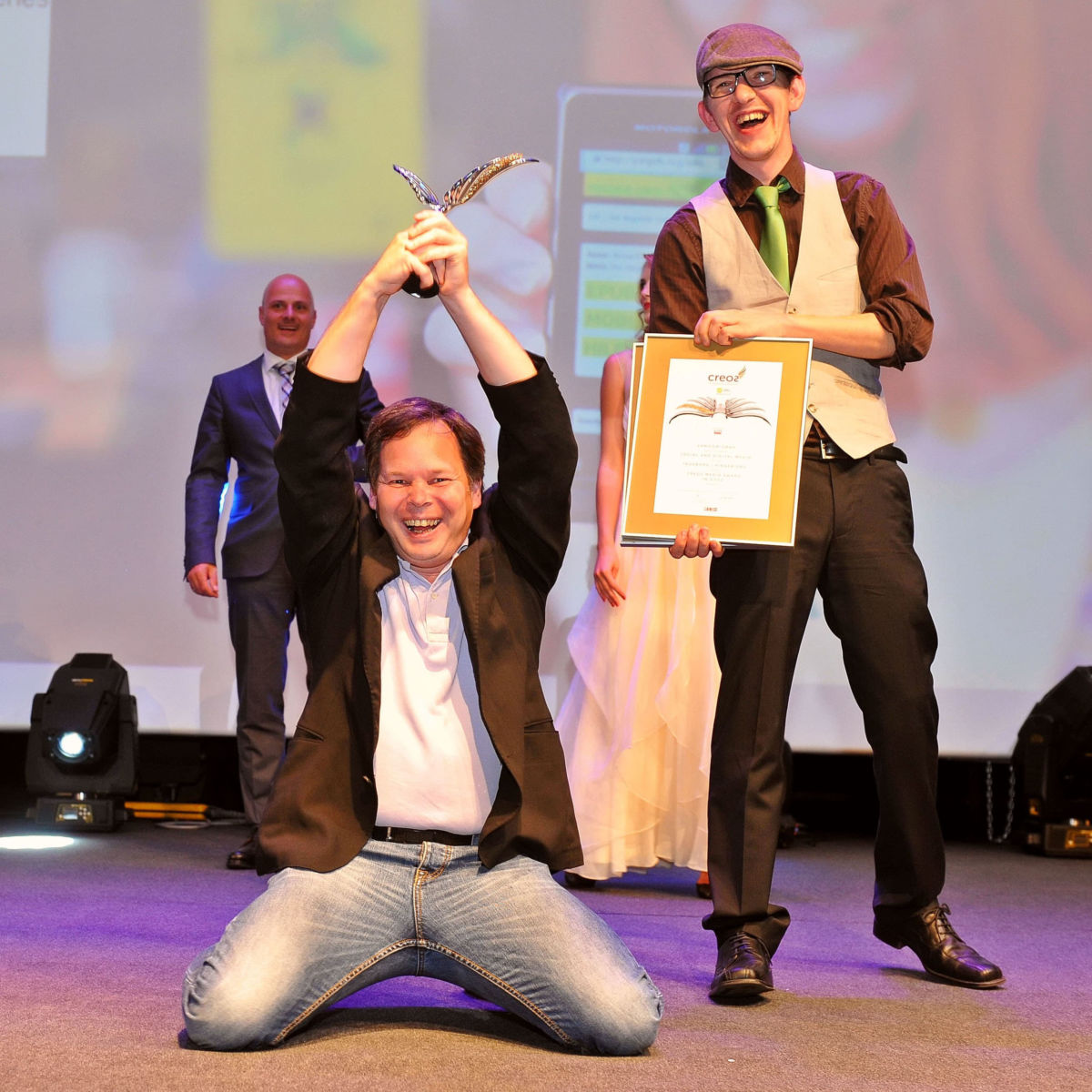Georg and Bruno pose as winners of a CREOS award in gold