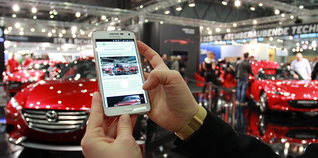 Smartphone at the Mazda booth showing information