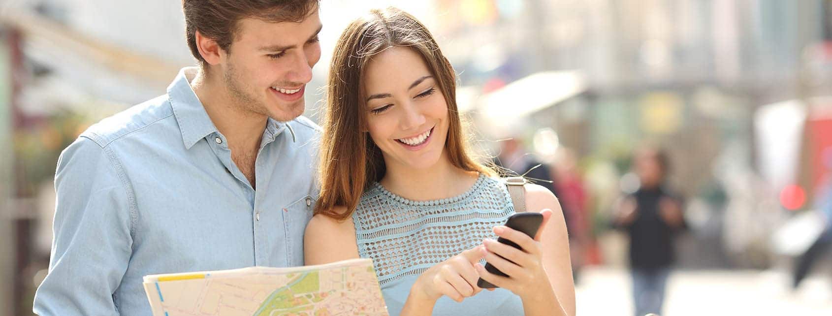 Tourists with smartphone and map:
